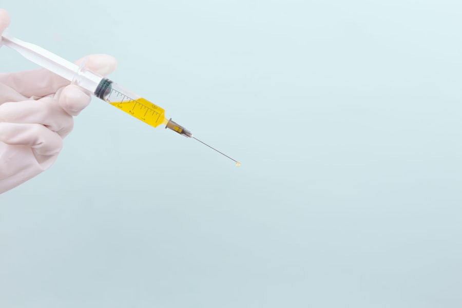 Gloved hand holding a vaccine syringe
